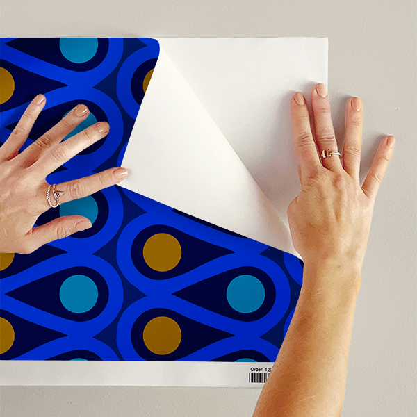 The artwork features a repetitive geometric pattern with curved, teal shapes creating loops that flow in symmetrical vertical columns. Inside the loops, there are solid circular shapes alternating between green and blue, with green circles in the left column and blue circles in the right column. The white background accentuates the vivid colors and clean lines of the design. The overall composition is balanced with a modern, vibrant aesthetic.